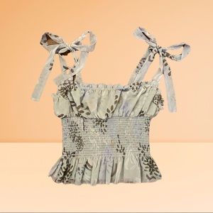 Beautiful top with such a unique design and style.The cute straps are adjustable